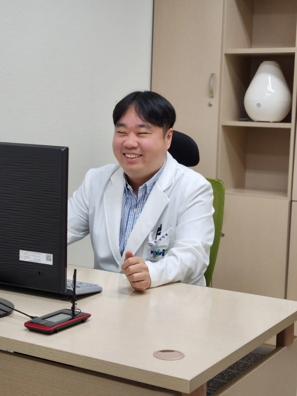 Inhyeok Yim smiling in a clinical office